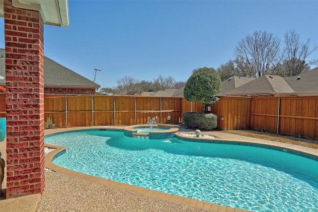 view of swimming pool featuring a fenced backyard and a pool with connected hot tub