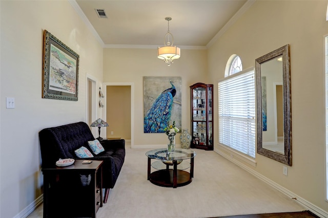 sitting room featuring visible vents, baseboards, carpet flooring, and crown molding