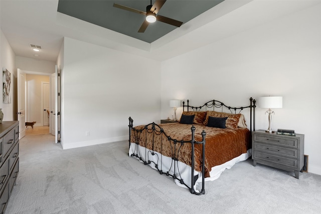 bedroom featuring visible vents, baseboards, a ceiling fan, and light carpet