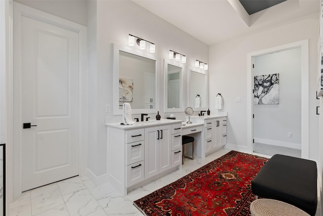 full bath featuring vanity, marble finish floor, and baseboards