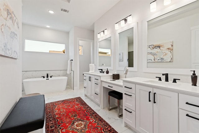 full bathroom with recessed lighting, a freestanding bath, marble finish floor, vanity, and visible vents