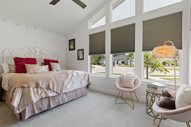 carpeted bedroom featuring baseboards, high vaulted ceiling, a ceiling fan, and multiple windows