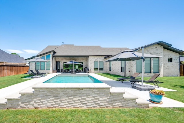 rear view of house with a patio, a fenced in pool, a lawn, brick siding, and fence