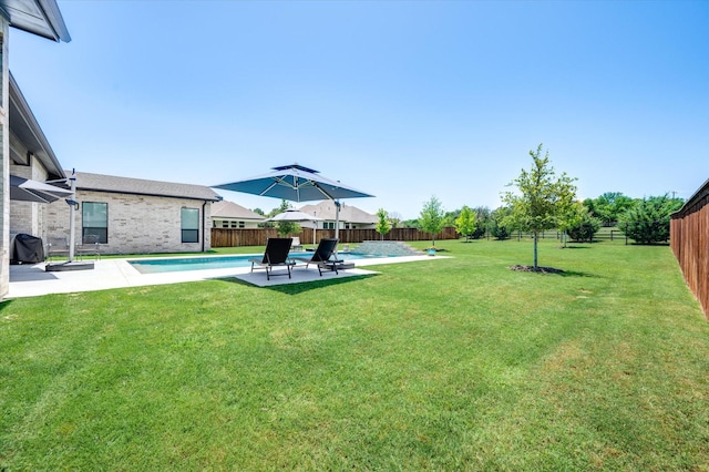 view of yard featuring a fenced in pool, a patio area, and a fenced backyard