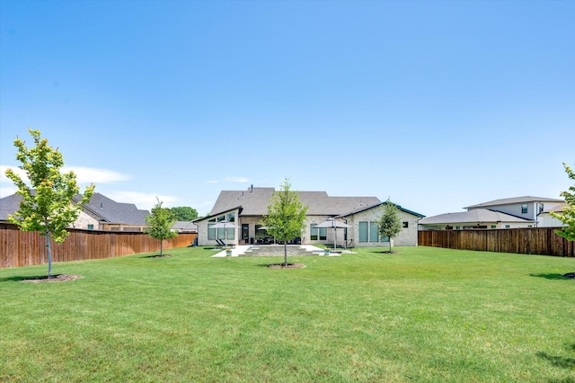 view of yard with a patio and a fenced backyard