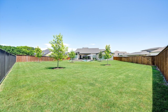 view of yard with a fenced backyard