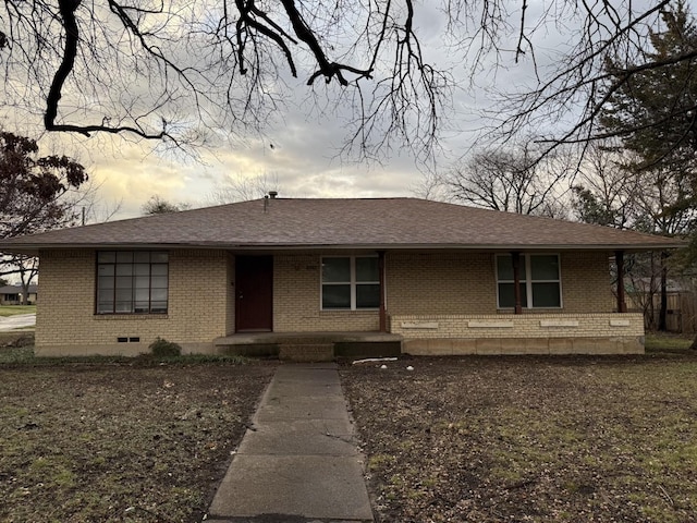 view of front of property with crawl space, brick siding, and a shingled roof