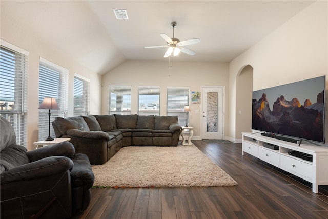 living room featuring visible vents, dark wood-type flooring, a ceiling fan, arched walkways, and lofted ceiling