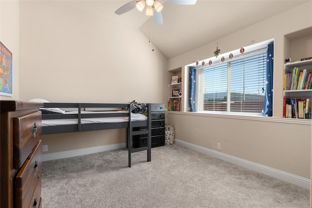 carpeted bedroom with ceiling fan, baseboards, and vaulted ceiling