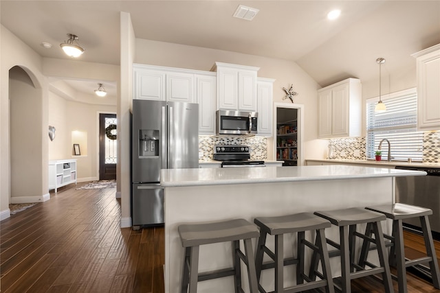 kitchen with visible vents, appliances with stainless steel finishes, light countertops, and dark wood-type flooring