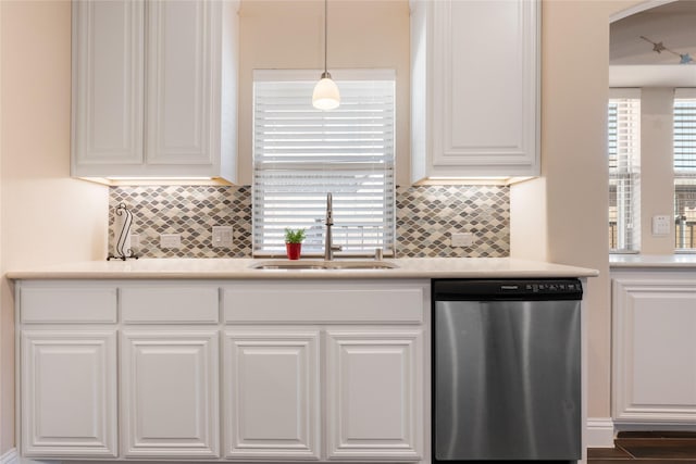 kitchen featuring white cabinetry, plenty of natural light, a sink, light countertops, and dishwasher