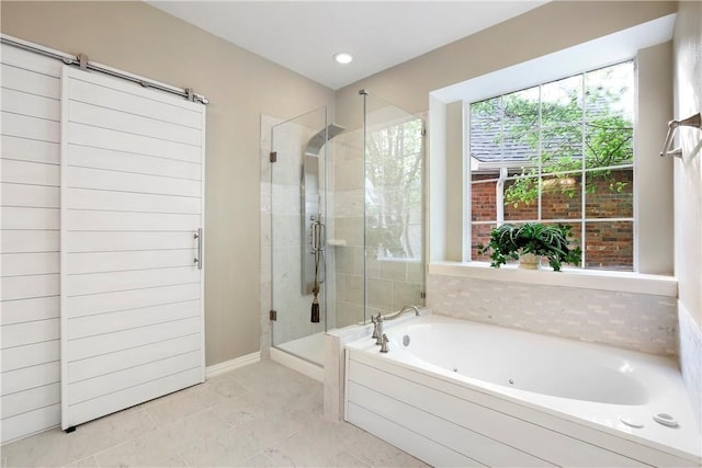 bathroom with a shower stall, a jetted tub, and baseboards