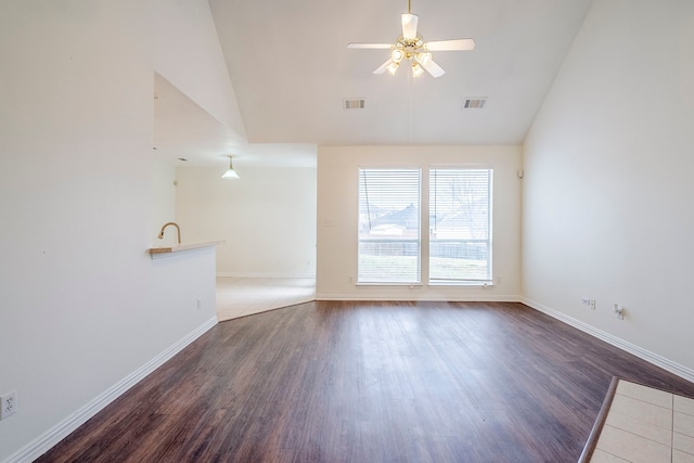 unfurnished living room featuring baseboards, wood finished floors, visible vents, and ceiling fan