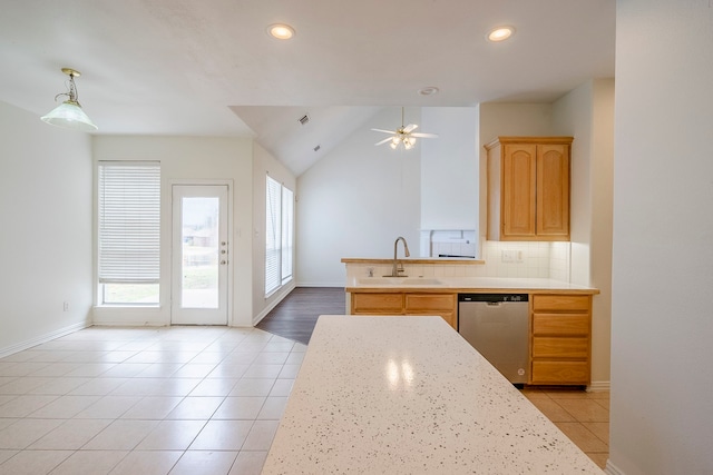 kitchen with dishwasher, light countertops, light tile patterned floors, and a sink