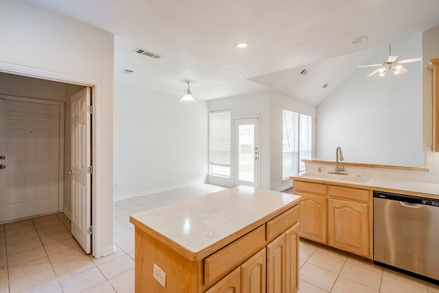 kitchen featuring visible vents, a sink, light countertops, lofted ceiling, and dishwasher