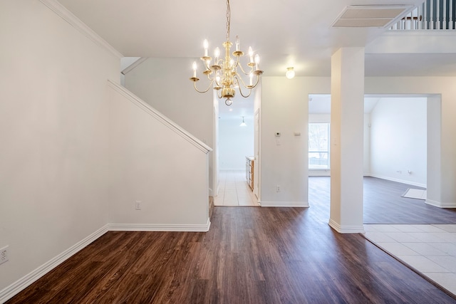 unfurnished dining area featuring visible vents, baseboards, wood finished floors, and stairway