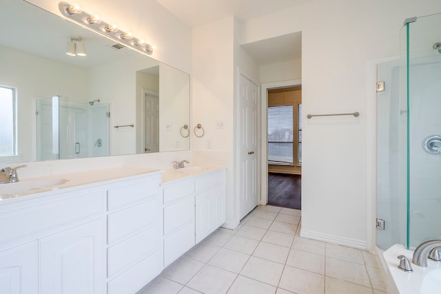 975 W Corporate Dr, Lewisville, TX 75067 - bathroom featuring tile patterned floors, a sink, a stall shower, and double vanity