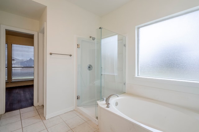 975 W Corporate Dr, Lewisville, TX 75067 - bathroom featuring a shower stall, tile patterned floors, baseboards, and a garden tub