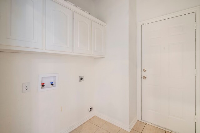 975 W Corporate Dr, Lewisville, TX 75067 - washroom featuring light tile patterned flooring, baseboards, washer hookup, electric dryer hookup, and cabinet space
