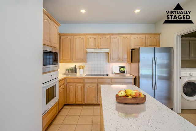 975 W Corporate Dr, Lewisville, TX 75067 - kitchen with light brown cabinetry, washer / clothes dryer, under cabinet range hood, and appliances with stainless steel finishes
