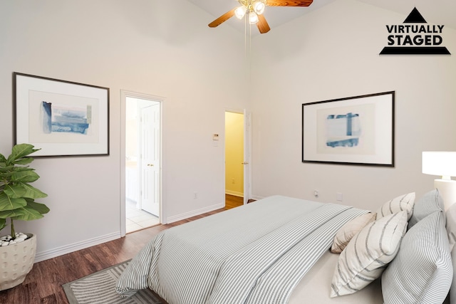 975 W Corporate Dr, Lewisville, TX 75067 - bedroom featuring baseboards, high vaulted ceiling, wood finished floors, and ensuite bathroom