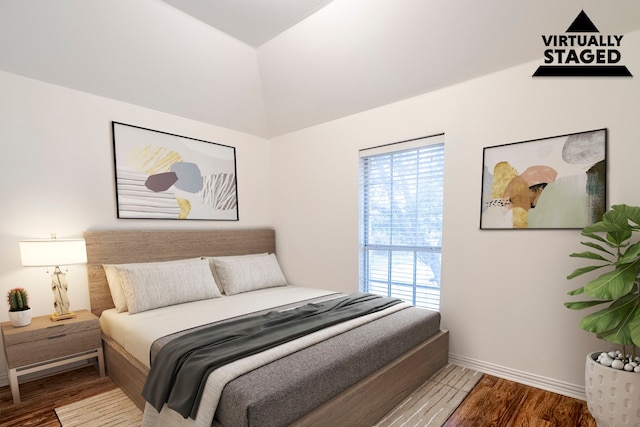 975 W Corporate Dr, Lewisville, TX 75067 - bedroom featuring baseboards, lofted ceiling, and wood finished floors