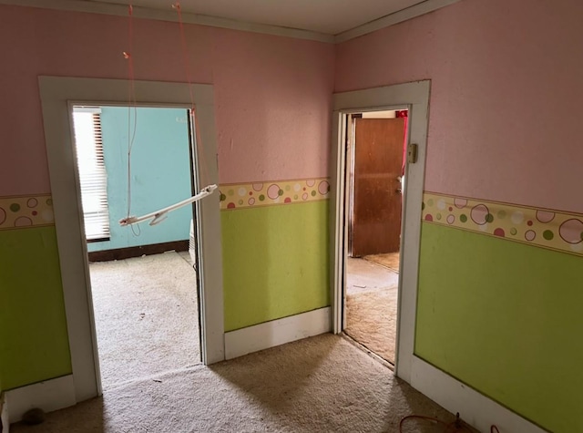 hallway with crown molding and carpet floors