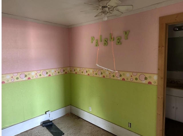 interior space with ornamental molding and a ceiling fan