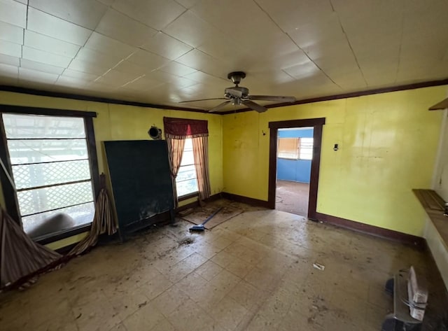 interior space featuring ceiling fan and baseboards