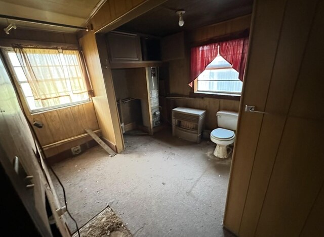 bathroom featuring toilet and wooden walls