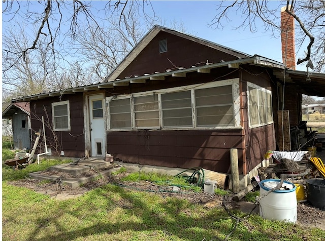 back of property featuring a chimney