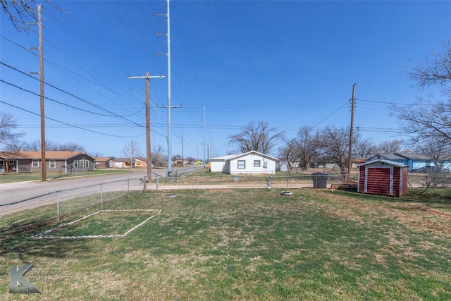 view of yard with a storage unit, an outdoor structure, and fence