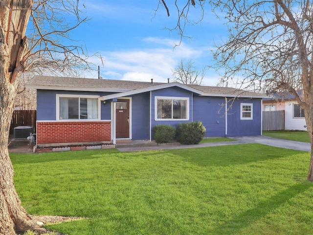 ranch-style home with brick siding, central AC unit, a front yard, and fence