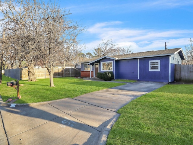 ranch-style house featuring brick siding, driveway, a front yard, and fence