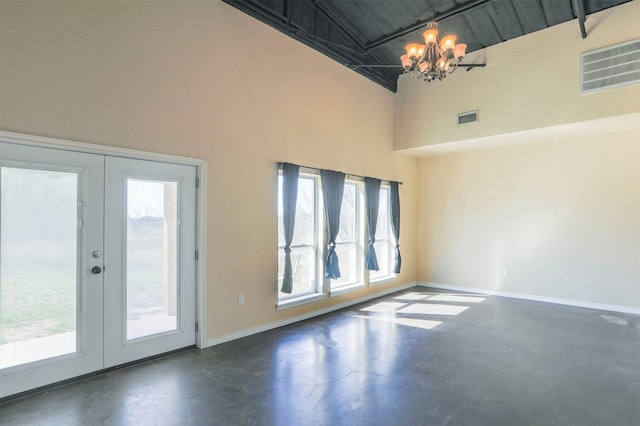 unfurnished room featuring visible vents, concrete floors, baseboards, a chandelier, and french doors