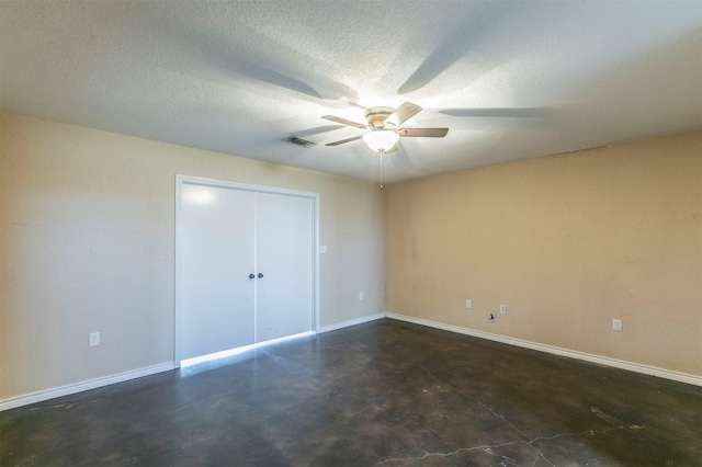 unfurnished bedroom featuring visible vents, a textured ceiling, concrete floors, and baseboards