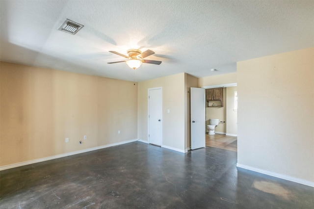 unfurnished room featuring visible vents, a ceiling fan, a textured ceiling, concrete floors, and baseboards