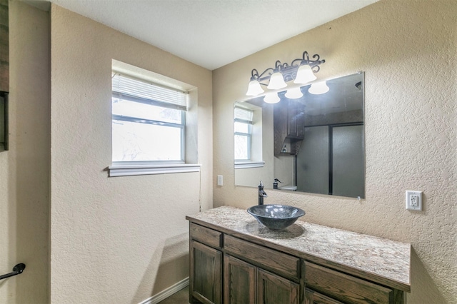 bathroom with vanity and a textured wall