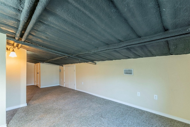 unfurnished room featuring visible vents, carpet flooring, and baseboards