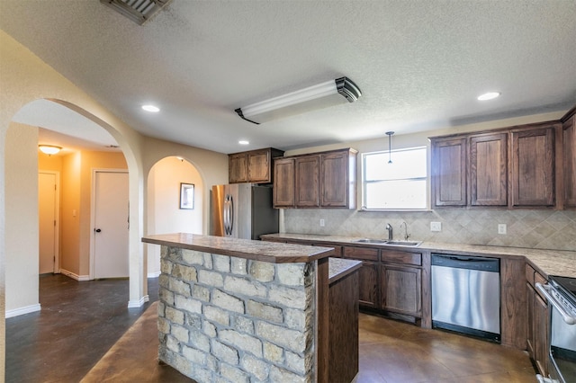 kitchen featuring decorative backsplash, appliances with stainless steel finishes, visible vents, and a sink