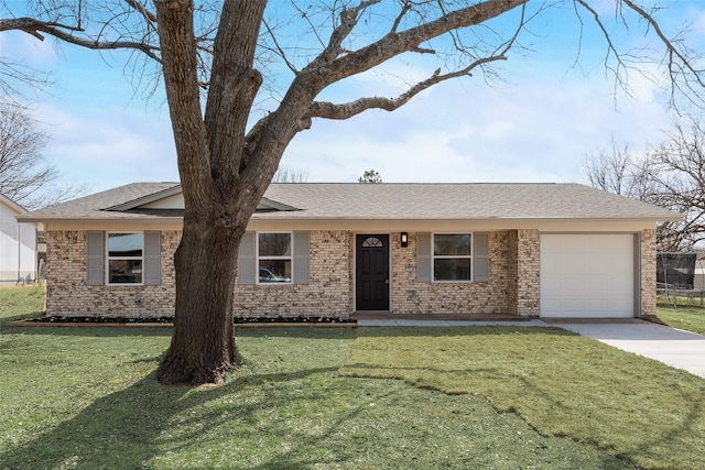 ranch-style house with a front yard, driveway, roof with shingles, a garage, and brick siding