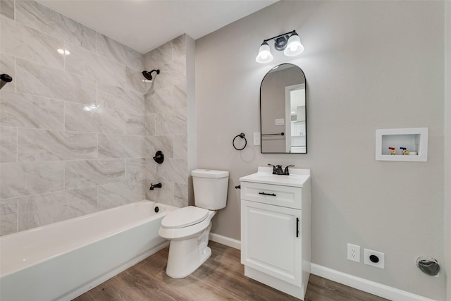 bathroom featuring toilet, shower / tub combination, baseboards, and wood finished floors