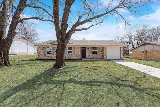 ranch-style home featuring a front lawn, concrete driveway, brick siding, and a garage