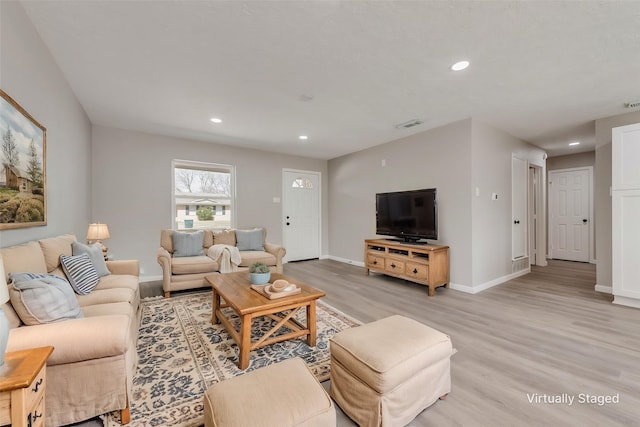 living room featuring visible vents, recessed lighting, baseboards, and light wood-style floors