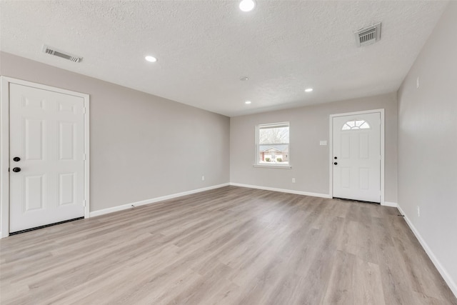 entrance foyer featuring baseboards, visible vents, and light wood-type flooring