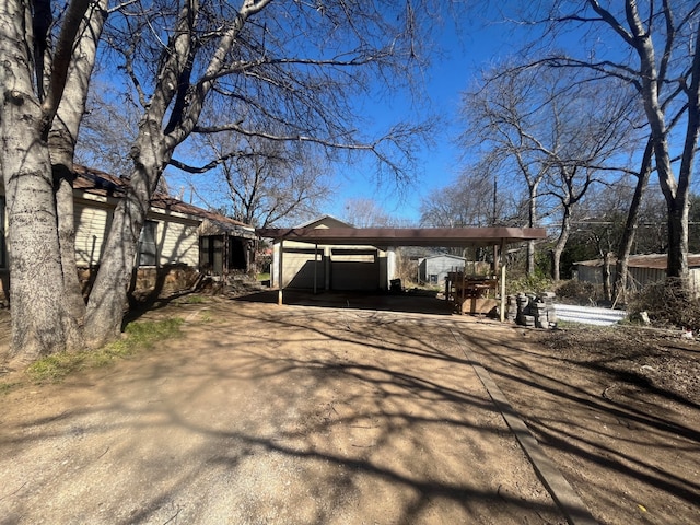 view of side of home featuring a carport and driveway