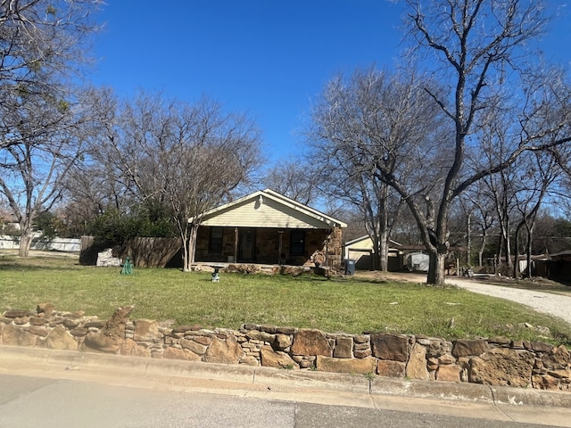 view of front of property with driveway, covered porch, and a front yard