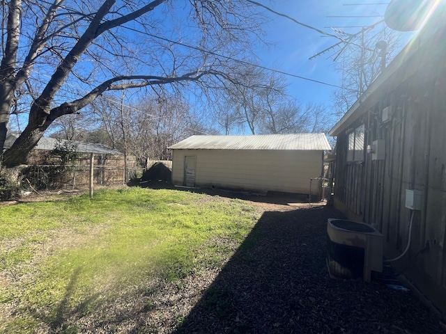 view of yard featuring central AC unit, an outdoor structure, and fence