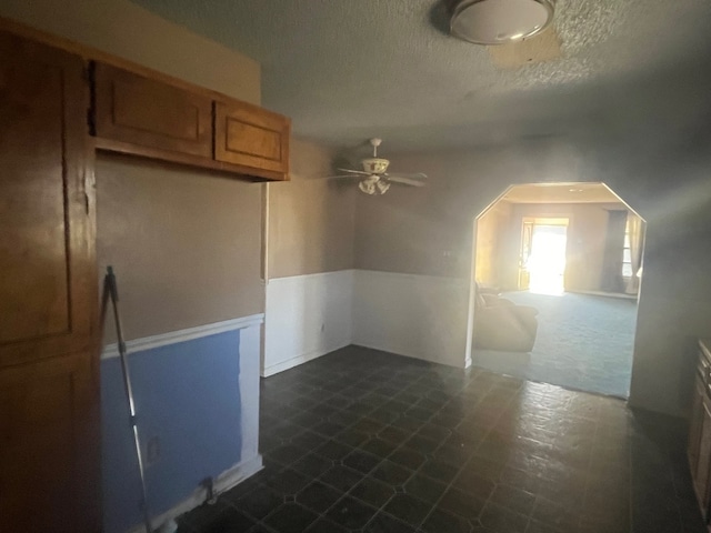 additional living space featuring ceiling fan and a textured ceiling