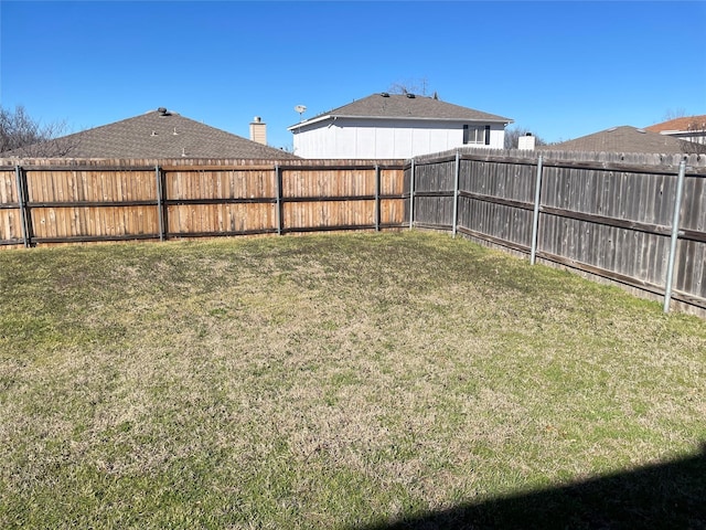 view of yard with a fenced backyard